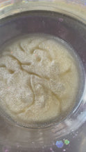 Load and play video in Gallery viewer, PIcture of a wax melt, which has melted and is shimmering on the top of a burner