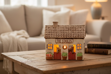 Load image into Gallery viewer, The Stables glowing with tealight - lifestyle shot