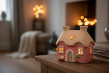 Load image into Gallery viewer, Pink Mini Cottage glowing with tealight - lifestyle shot
